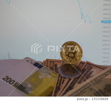 gold coin bitcoin on dollar bills on the background of the graph gold coin bitcoin on dollar bills on the background of the graph 135338689