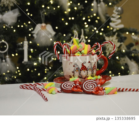 beautiful New Year's Eve cup with marshmallow marshmallows and candy canes beautiful New Year's Eve cup with marshmallow marshmallows and candy canes 135338695