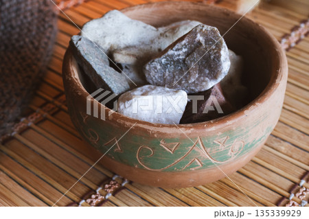 Bowl with stones creating a serene atmosphere for a spiritual ritual, isolated Bowl with stones creating a serene atmosphere for a spiritual ritual, isolated 135339929