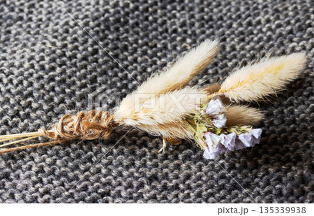 Small dried bouquet of fluffy bunny tail grass and purple statice tied with rustic jute twine. Small dried bouquet of fluffy bunny tail grass and purple statice tied with rustic jute twine. 135339938