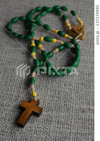 Rosary beads with a wooden cross, symbolizing Christian prayer, devotion and tradition Rosary beads with a wooden cross, symbolizing Christian prayer, devotion and tradition 135339985