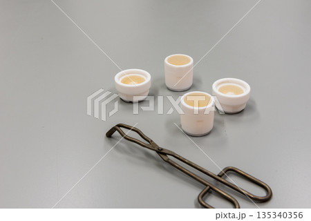 Forceps and grinding jars of mixer mills are used for the pulverization. Laboratory equipment. Forceps and grinding jars of mixer mills are used for the pulverization. Laboratory equipment. 135340356