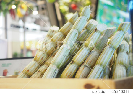 Sugar cane stacked in a wooden crate at a market Sugar cane stacked in a wooden crate at a market 135340811