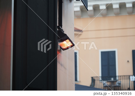 Light source mounted on wall near building entrance Light source mounted on wall near building entrance 135340916