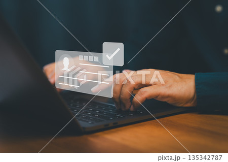 Digital identity verification and user authentication concept showing a person using laptop computer with a virtual ID card and check mark symbolizing secure login, data privacy and account approval. 135342787