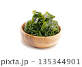 Seaweed wakame in wood bowl on white background. 135344901