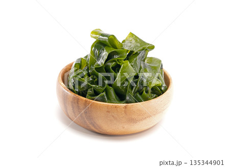 Seaweed wakame in wood bowl on white background. Seaweed wakame in wood bowl on white background. 135344901
