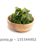 Seaweed wakame in wood bowl on white background. 135344902