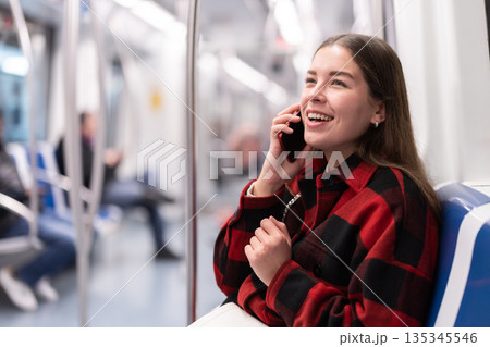 Girl sit in tram car and emotionally talks on phone, getting to work 135345546
