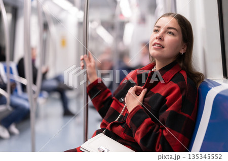 Girl sit in tram car, getting to work 135345552