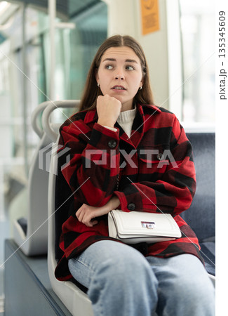 Girl sit in tram car, getting to work Girl sit in tram car, getting to work 135345609