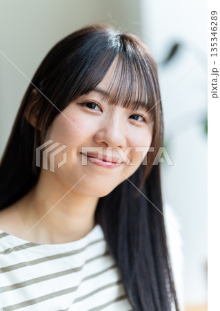 明るい笑顔でこちらを見つめる女性の顔アップ 135346289