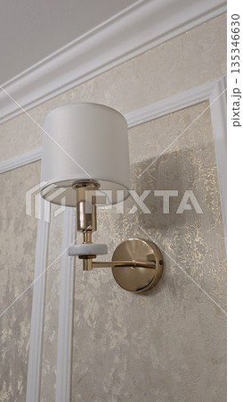 Luxurious wallmounted lights create inviting hotel corridor ambiance 135346630
