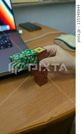 Designer Tests Prototype During Break, Calm Scene Of Designer Testing Tactile Prototype With Wood Blocks 135346644