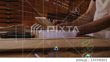 Operating adult male technician using tablet on wooden workbench with metal tools, with AR charts Operating adult male technician using tablet on wooden workbench with metal tools, with AR charts 135346801