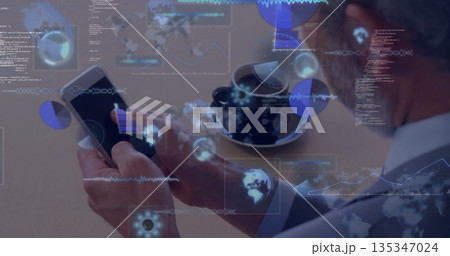 Studying businessman holding smartphone and viewing data charts at wooden table with coffee cup 135347024