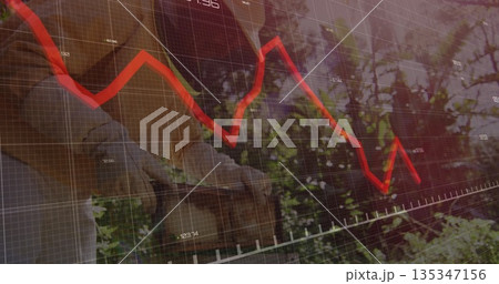 Gardener wearing shirt, gloves picking greenery in yard, with wicker basket and red trendline chart 135347156