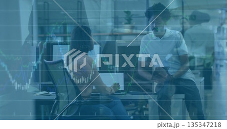 Colleagues analyzing monitor data and consulting tablet at office desk, overlaying financial charts Colleagues analyzing monitor data and consulting tablet at office desk, overlaying financial charts 135347218