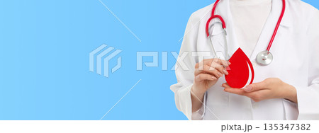 Medics promote blood donation with drop symbol Medics promote blood donation with drop symbol 135347382