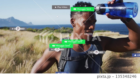 Pausing adult hiker holding blue bottle to forehead on coastal dirt trail, with black backpack Pausing adult hiker holding blue bottle to forehead on coastal dirt trail, with black backpack 135348246