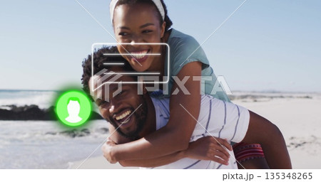 Couple wearing beach clothes giving piggyback ride at shore, with chat bubble and green user icon Couple wearing beach clothes giving piggyback ride at shore, with chat bubble and green user icon 135348265