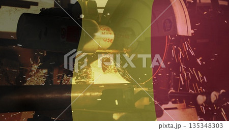 Grinding metal pipe on bench grinder at metal workshop, with shower of sparks nearby Grinding metal pipe on bench grinder at metal workshop, with shower of sparks nearby 135348303