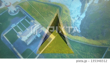 Overlooking lighthouse complex on coastal cliff top with triangular graphic overlay, copy space 135348312