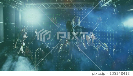 Riding male crowd-surfer being held aloft by fans in club space, with moving head spotlights Riding male crowd-surfer being held aloft by fans in club space, with moving head spotlights 135348412