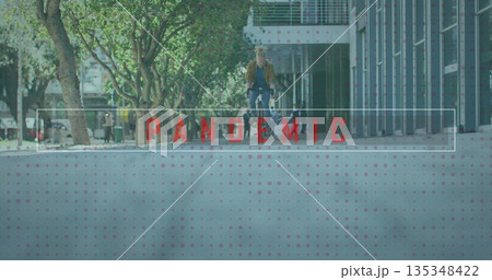 Riding bicycle, man wearing tan jacket and backpack gliding down urban boulevard, with lampposts 135348422
