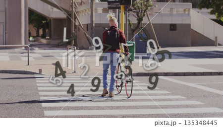 Man wearing red shirt pushing bicycle across zebra crosswalk at city intersection, with backpack Man wearing red shirt pushing bicycle across zebra crosswalk at city intersection, with backpack 135348445