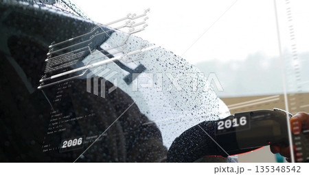 Connecting electric car connector into port at station, with raindrops circuit overlay, copy space Connecting electric car connector into port at station, with raindrops circuit overlay, copy space 135348542