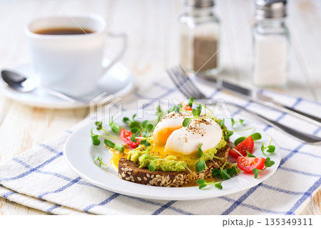 Healthy diet sandwiches for breakfast, toast with guacamole avocado and poached egg with wholemeal bread. Healthy diet sandwiches for breakfast, toast with guacamole avocado and poached egg with wholemeal bread. 135349311