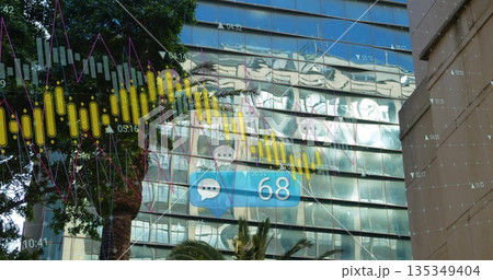Displaying digital analytics overlay on glass-paneled office facade with palm tree, graffiti murals 135349404