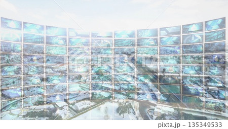 Displaying curved monitor wall projecting binary code and globes in control room over snowy suburb 135349533