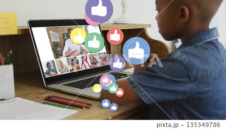Typing boy on silver laptop at home, with pencils, notebook, thumbs up icons, copy space Typing boy on silver laptop at home, with pencils, notebook, thumbs up icons, copy space 135349786