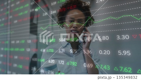 Holding coffee cup and smartphone, woman wearing blue shirt analyzing market data at office, screen Holding coffee cup and smartphone, woman wearing blue shirt analyzing market data at office, screen 135349832