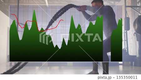 Swinging Black man exercising with battle ropes at warehouse gym, chart overlay, copy space Swinging Black man exercising with battle ropes at warehouse gym, chart overlay, copy space 135350011