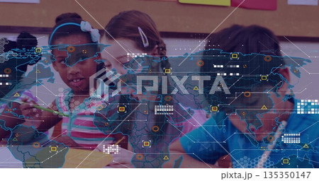 Drawing group of children using colored pencils at classroom table, with digital world map overlay 135350147
