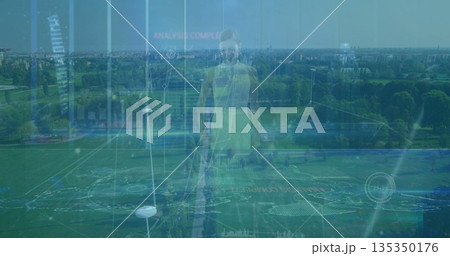 Standing woman wearing neon green sportswear at aerial park sports field markings, data panels 135350176