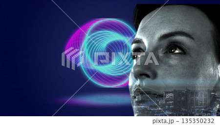 Smiling woman in cap gazing upward in studio, with neon spiral, city skyline overlay, copy space 135350232