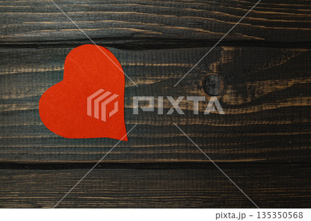 Red heart shape on wooden surface creating a simple design 135350568