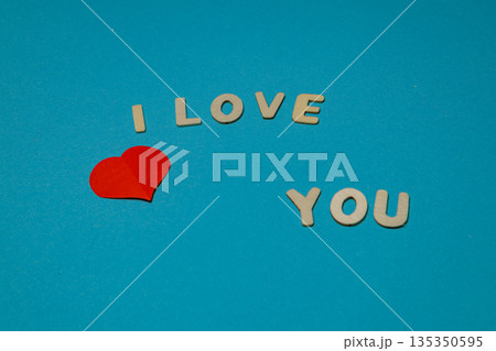 Letters and heart form a message on a blue background Letters and heart form a message on a blue background 135350595