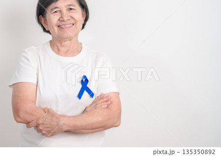 Elderly with dark Blue or Navy blue Ribbon for concept of March Colorectal and Colon Cancer Awareness month, May Arthritis awareness, July Juvenile arthritis and Childhood. Health and world cancer day Elderly with dark Blue or Navy blue Ribbon for concept of March Colorectal and Colon Cancer Awareness month, May Arthritis awareness, July Juvenile arthritis and Childhood. Health and world cancer day 135350892