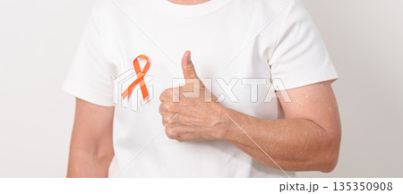 Elderly with Orange Ribbon for September Leukemia, March Kidney cancer day, Multiple Sclerosis, Self Injury Awareness month, November Complex Regional Pain Syndrome, CRPS, COPD disease concept 135350908