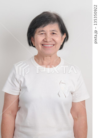 Elderly with White ribbon for concept November Lung Cancer Awareness month, Stop Violence Against Women, Adoption, May Retinoblastoma, Action for Women Health, March Remembrance, October Osteoporosis Elderly with White ribbon for concept November Lung Cancer Awareness month, Stop Violence Against Women, Adoption, May Retinoblastoma, Action for Women Health, March Remembrance, October Osteoporosis 135350922