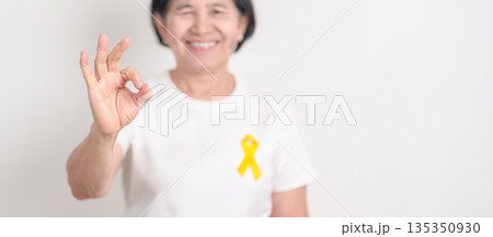 Elderly with Yellow Ribbon for concept of yellow September, Suicide prevention day, Childhood, July Sarcoma, March Endometriosis awareness month , support survivor. Healthcare and World Cancer day Elderly with Yellow Ribbon for concept of yellow September, Suicide prevention day, Childhood, July Sarcoma, March Endometriosis awareness month , support survivor. Healthcare and World Cancer day 135350930