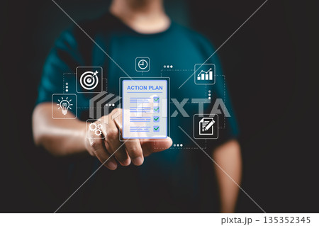 Businessman pointing at digital action plan with icons for strategy, time management, and growth 135352345