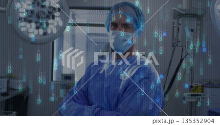 Standing surgeon wearing mask, hairnet, blue gown under lights in OR, with floating binary code 135352904