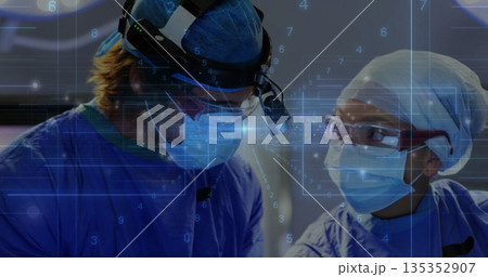 Working surgeons wearing masks and gowns, examining patient in operating room, with digital overlay Working surgeons wearing masks and gowns, examining patient in operating room, with digital overlay 135352907