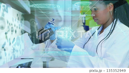 Scientist in lab coat transferring liquid with pipette into vial at lab bench, holographic overlays Scientist in lab coat transferring liquid with pipette into vial at lab bench, holographic overlays 135352949